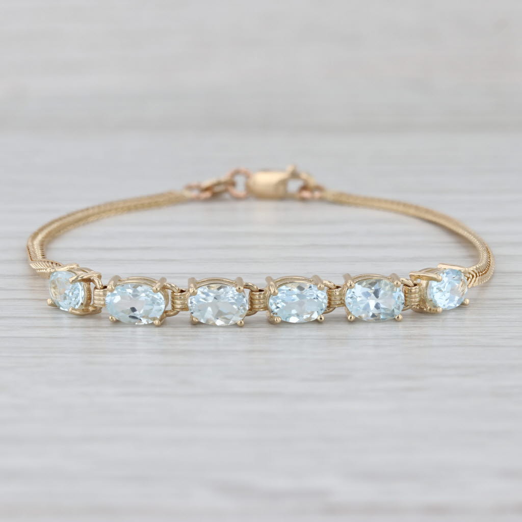 3.10ctw Blue Topaz Bracelet 14k Yellow Gold 6.5" Herringbone Chain