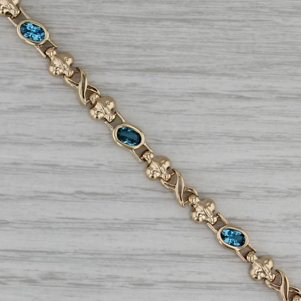 2.68ctw Blue Topaz Infinity Knot Bracelet 14k Yellow Gold 6.75" 6mm