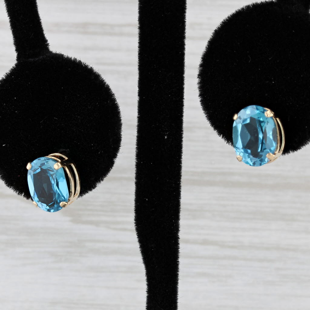 Light Gray 4ctw Oval Blue Topaz Stud Earrings 14k Yellow Gold