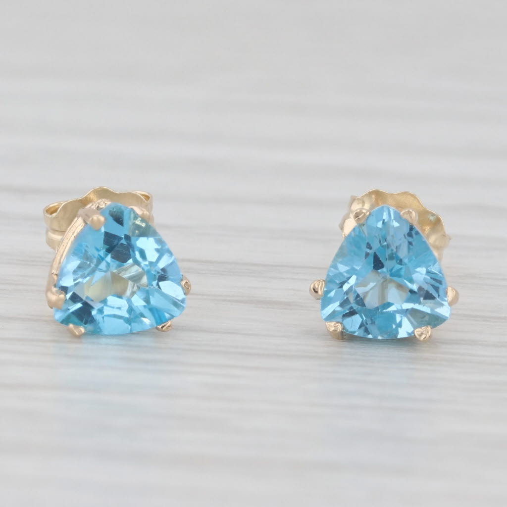 Light Gray 2ctw Blue Topaz Stud Earrings 10k Yellow Gold Trillion Solitaires