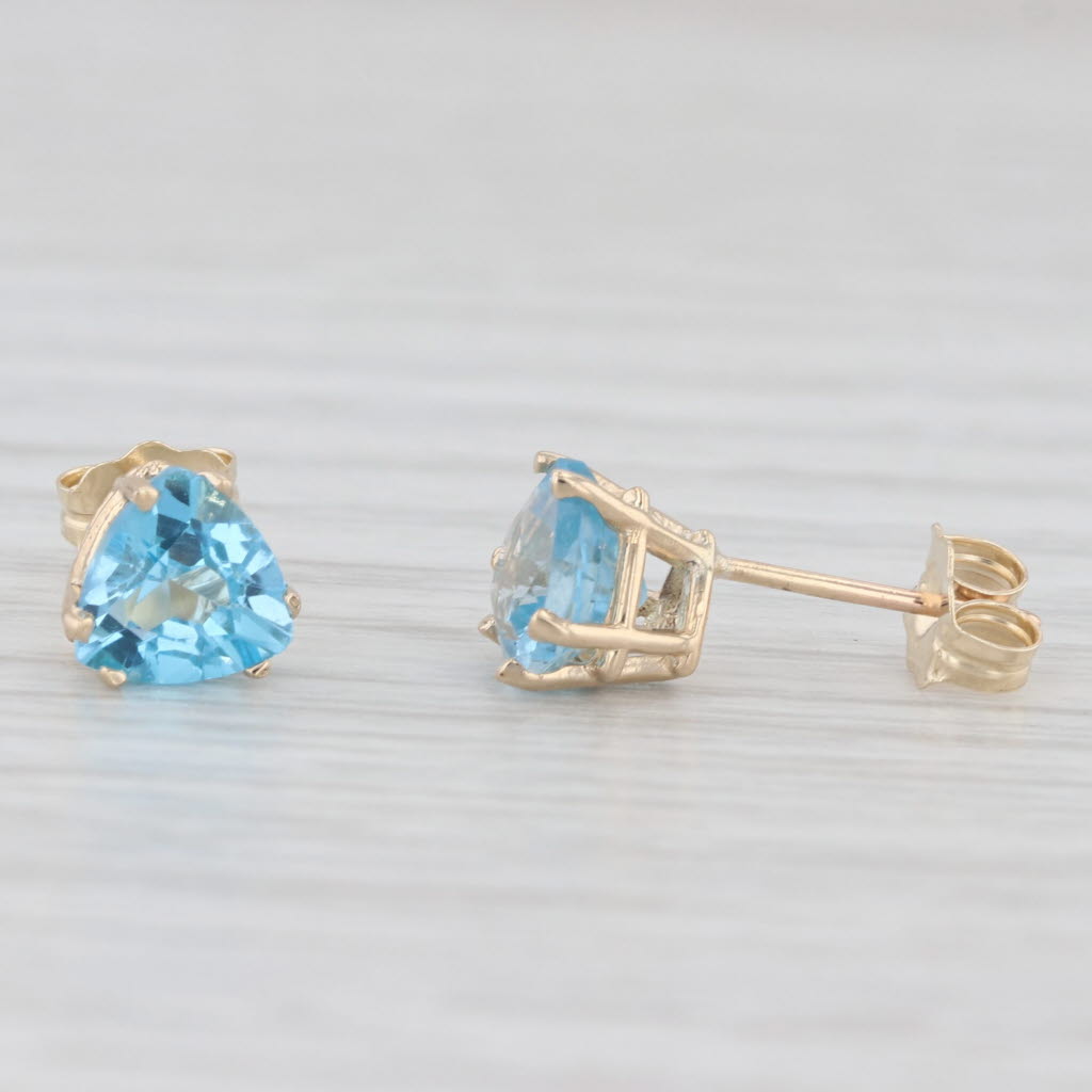Light Gray 2ctw Blue Topaz Stud Earrings 10k Yellow Gold Trillion Solitaires