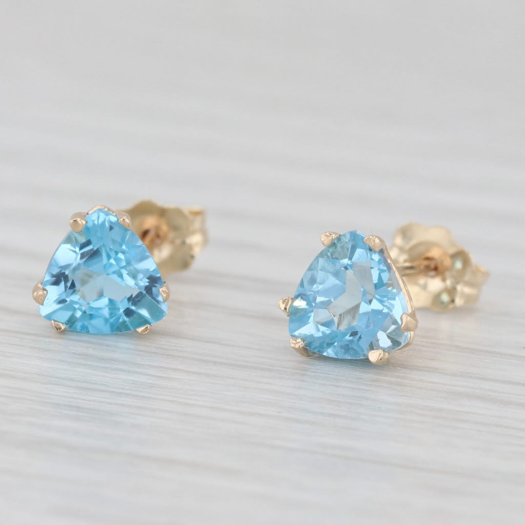 Light Gray 2ctw Blue Topaz Stud Earrings 10k Yellow Gold Trillion Solitaires