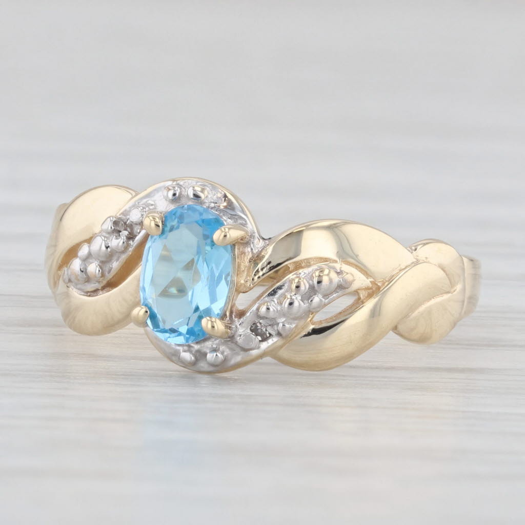 Light Gray 0.40ct Oval Blue Topaz Ring 10k Yellow Gold Diamond Accents Size 6.5