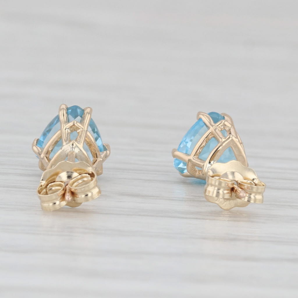 Light Gray 2ctw Blue Topaz Stud Earrings 10k Yellow Gold Trillion Solitaires