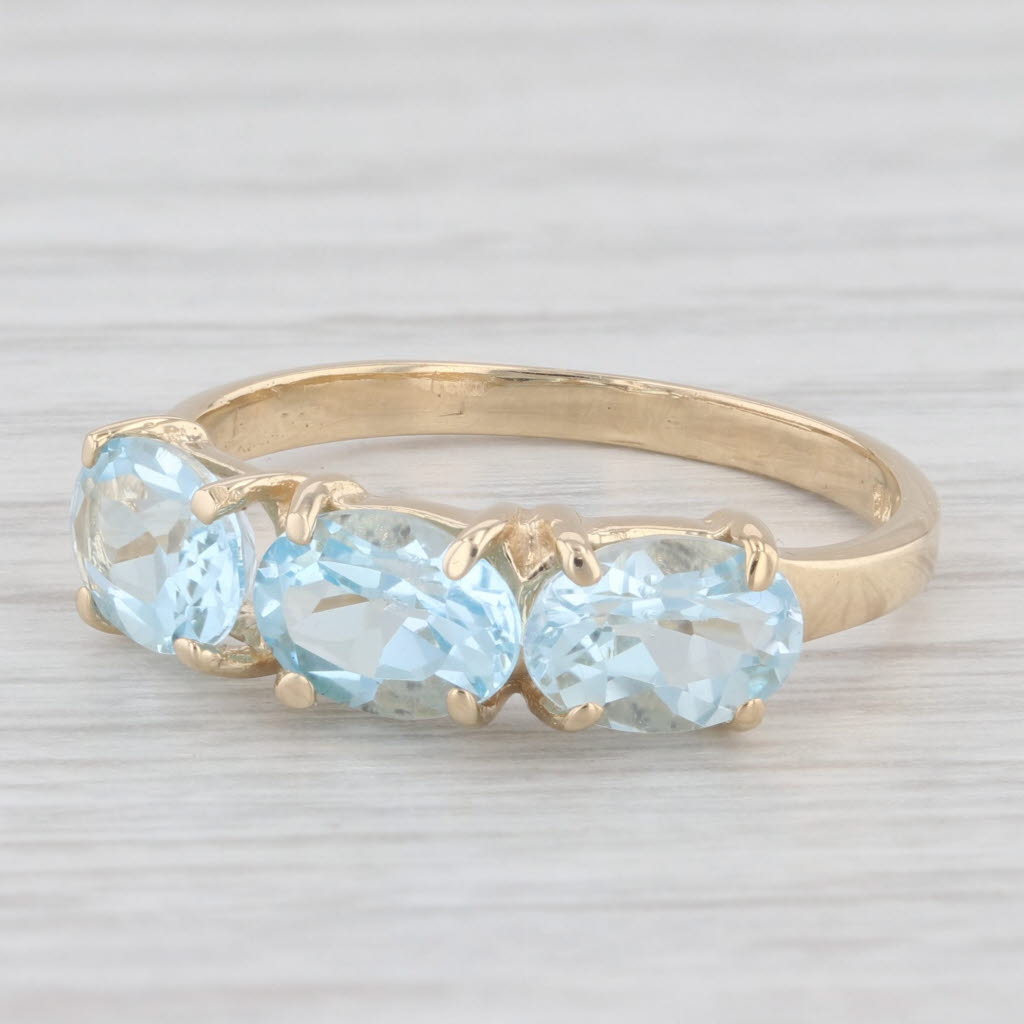 Light Gray 3ctw 3-Stone Oval Blue Topaz Ring 14k Yellow Gold Size 8