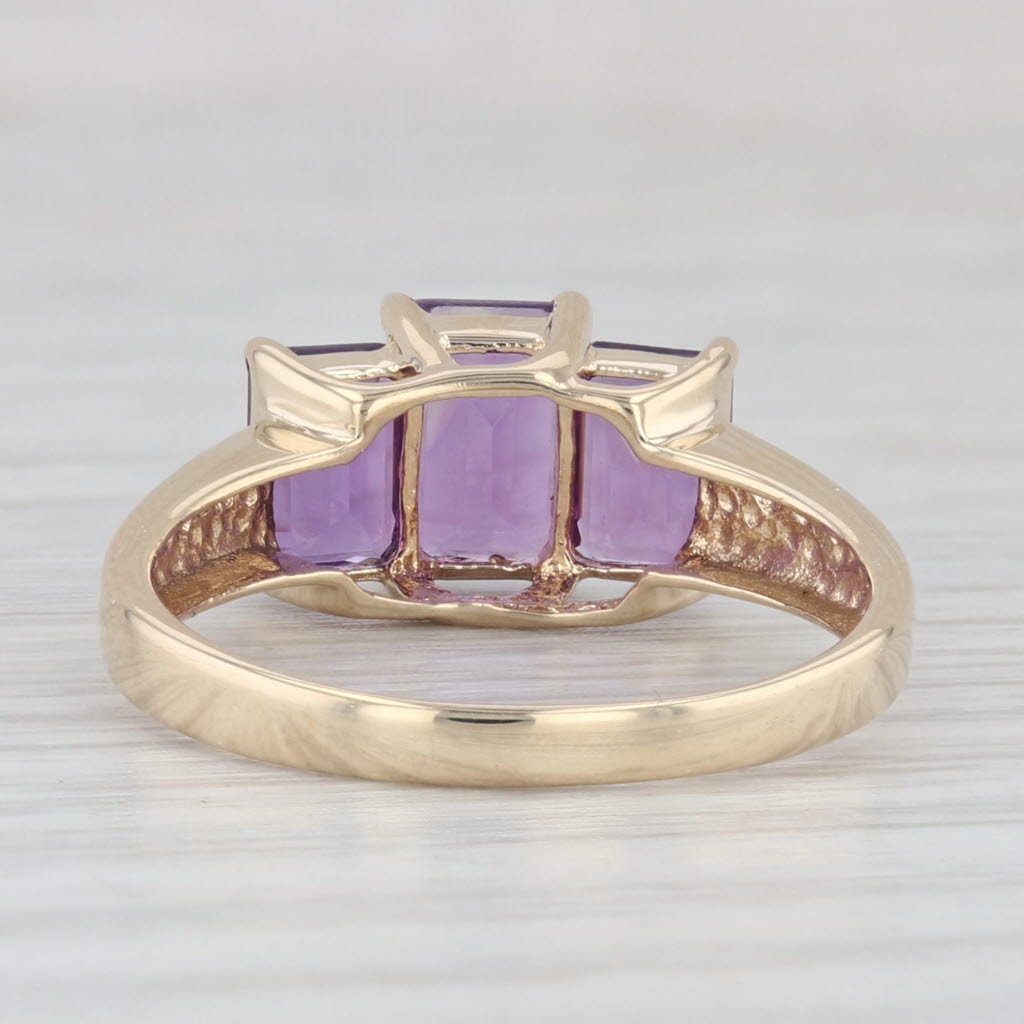 Light Gray 1.88ctw 3-Stone Emerald Cut Amethyst Ring 10k Yellow Gold Size 7.5