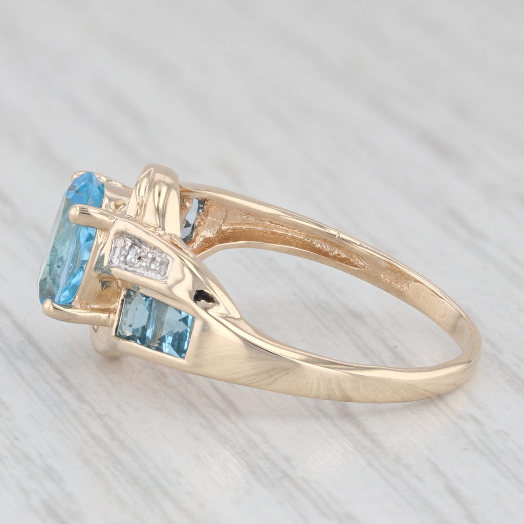 Light Gray 2.30ctw Oval Blue Topaz Bypass Ring 10k Yellow Gold Size 7.25 Diamond Accents