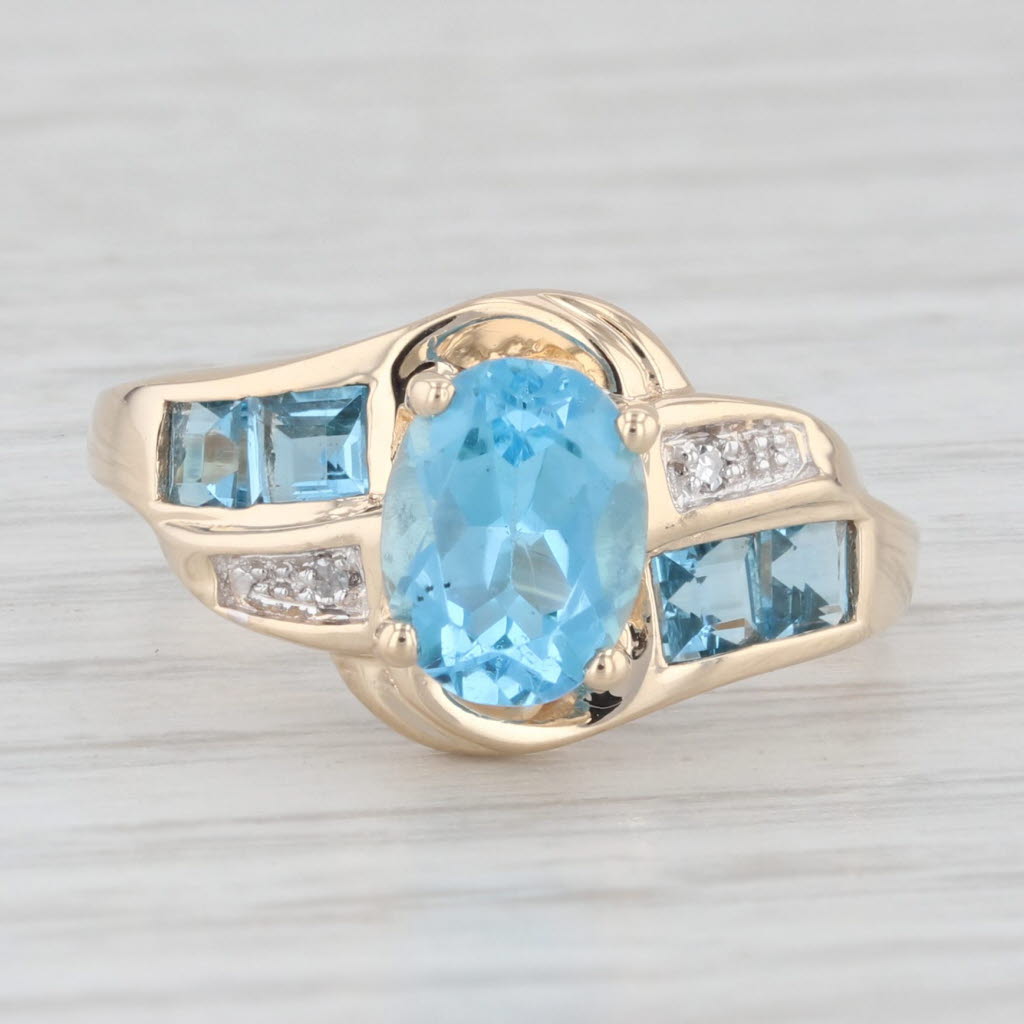 Light Gray 2.30ctw Oval Blue Topaz Bypass Ring 10k Yellow Gold Size 7.25 Diamond Accents