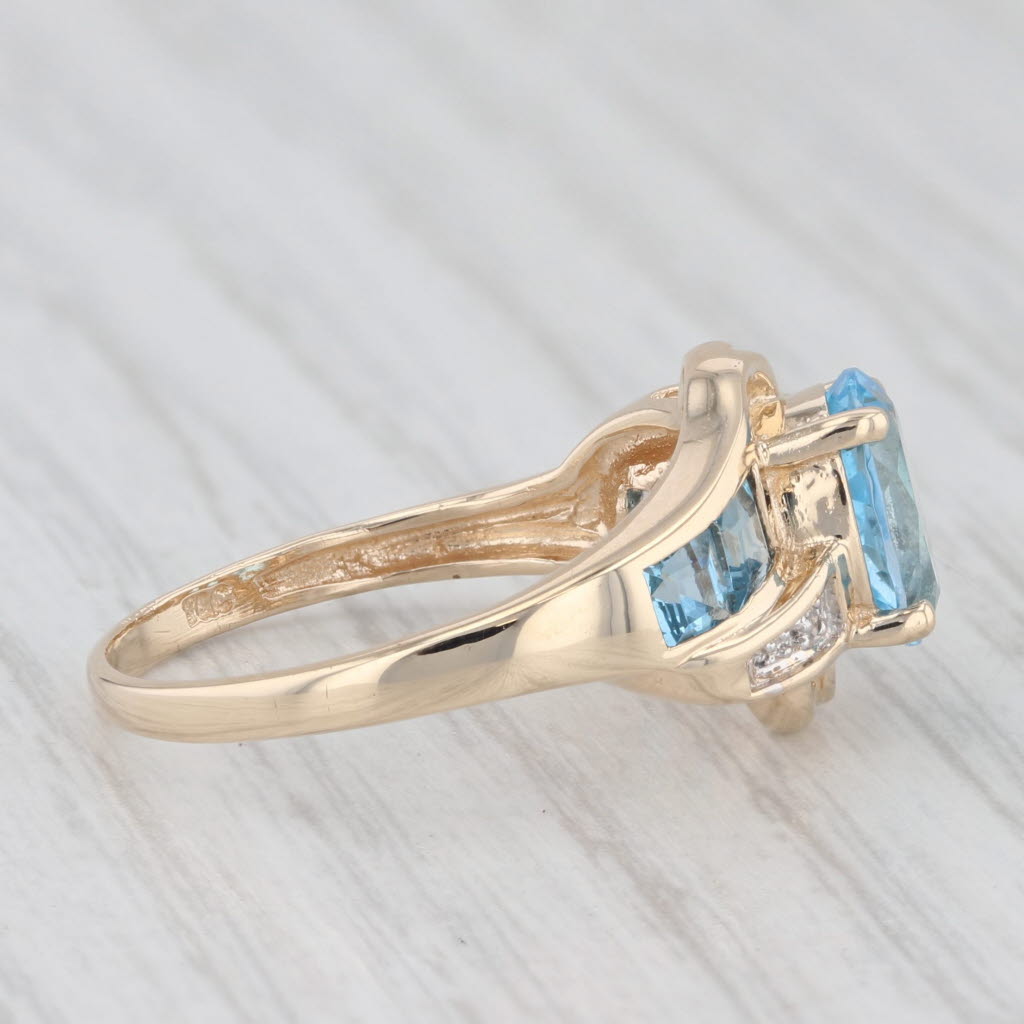 Light Gray 2.30ctw Oval Blue Topaz Bypass Ring 10k Yellow Gold Size 7.25 Diamond Accents