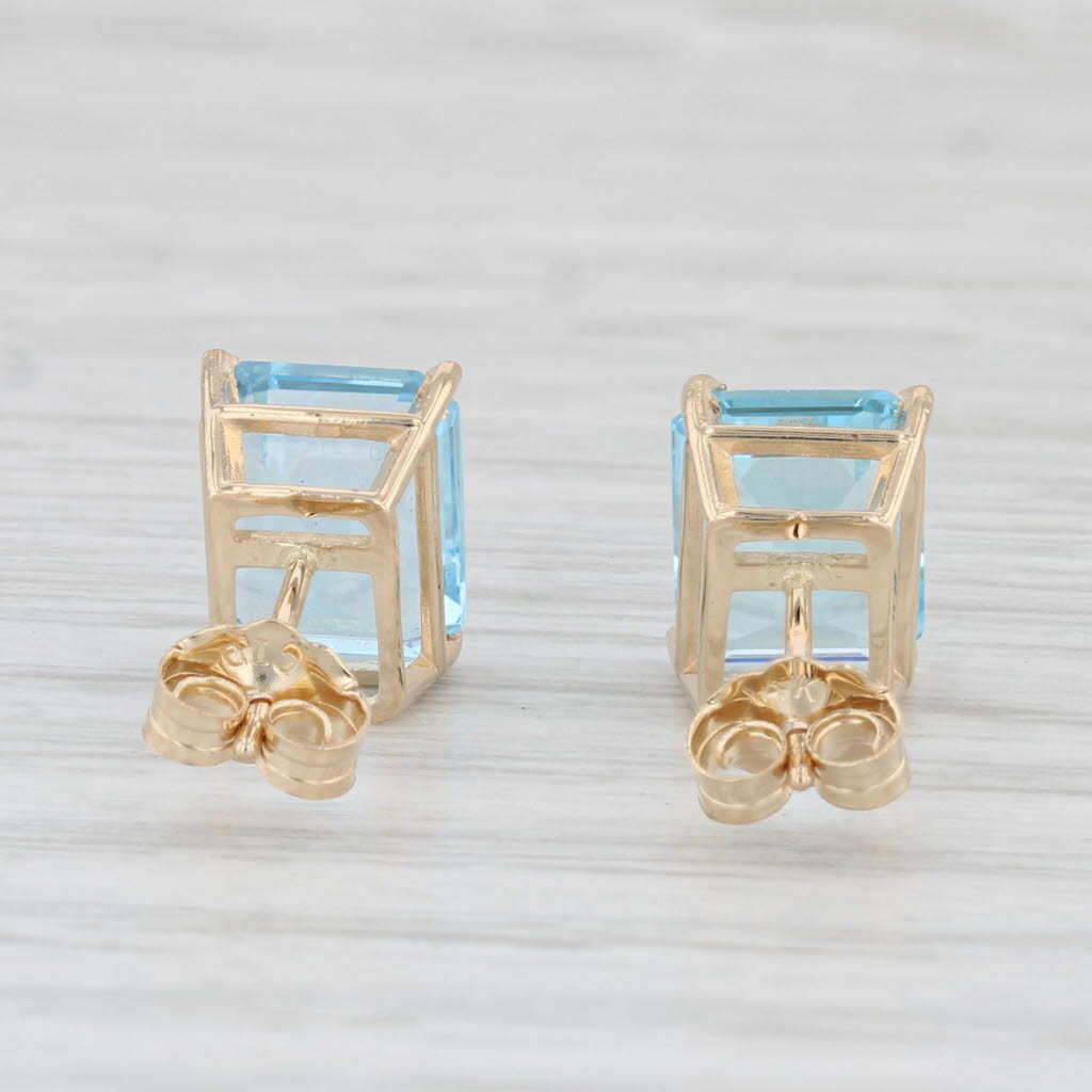 Light Gray 6ctw Blue Topaz Stud Earrings 14k Yellow Gold Emerald Cut Solitaires