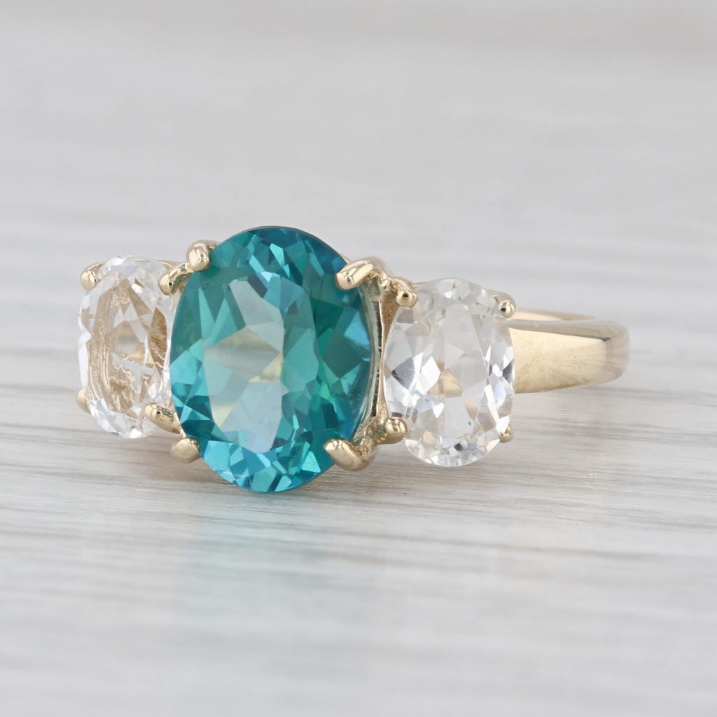 4.80ctw Teal & White Topaz Oval 3-Stone Ring 10k Yellow Gold Size 6