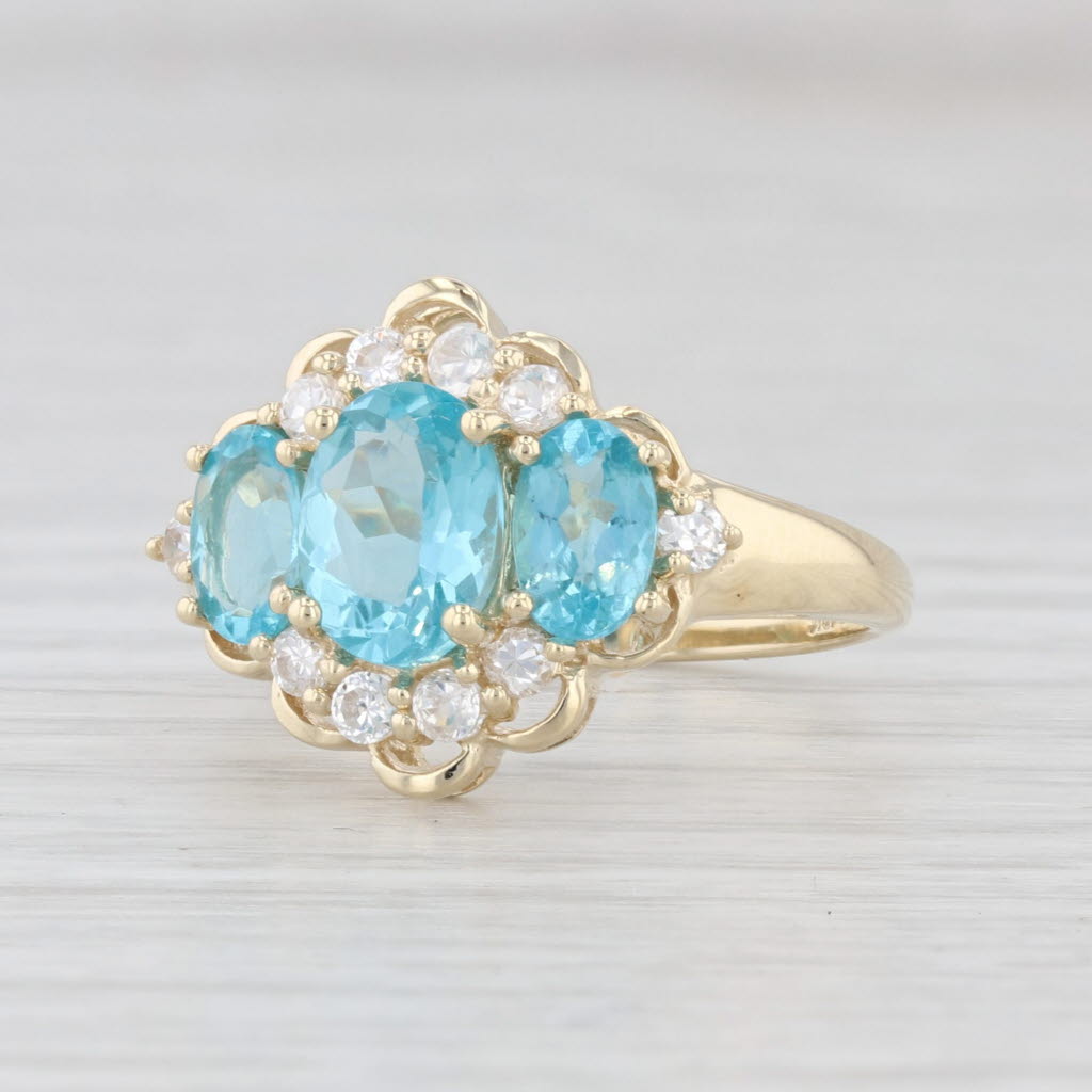 Light Gray 2.31ctw Blue Apatite 3-Stone Cubic Zirconia Ring 10k Yellow Gold Size 7