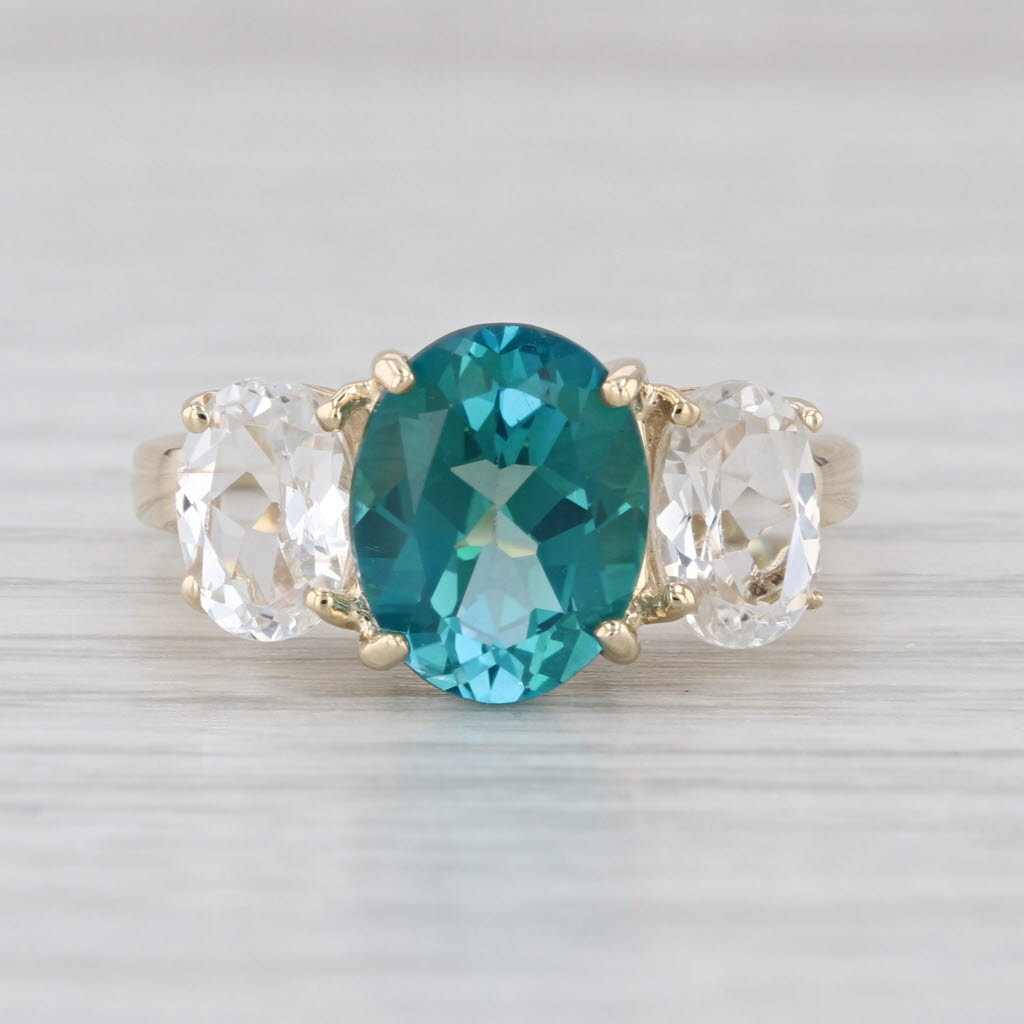 4.80ctw Teal & White Topaz Oval 3-Stone Ring 10k Yellow Gold Size 6