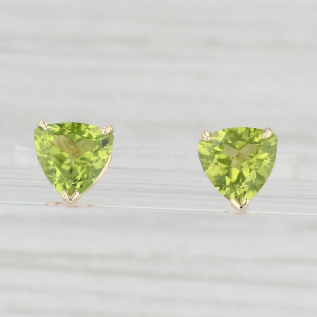 Light Gray 3.20ctw Green Peridot Stud Earrings 14k Yellow Gold Trillion Cut Studs