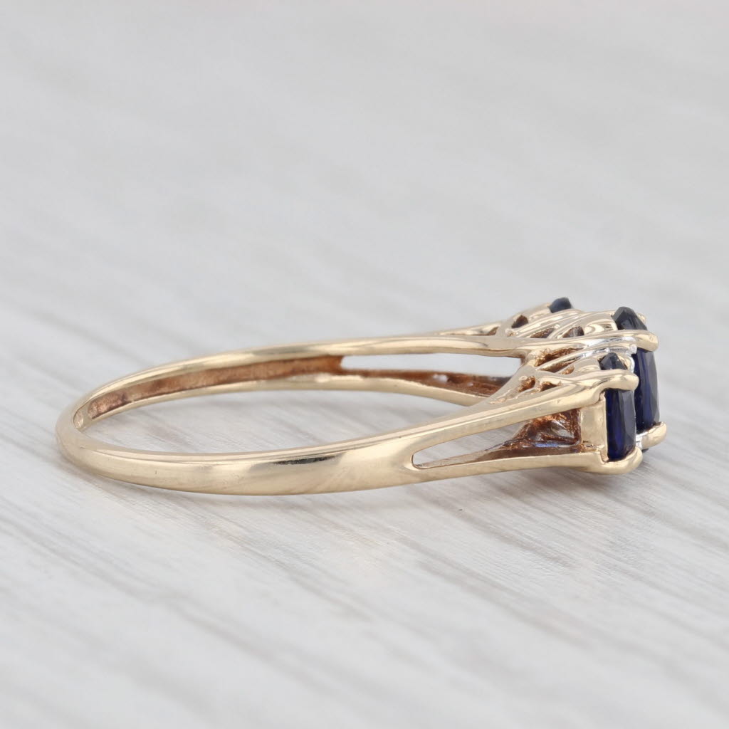 Light Gray 1.20ctw Lab Created Blue Sapphire 3-Stone Ring 10k Yellow Gold Size 7