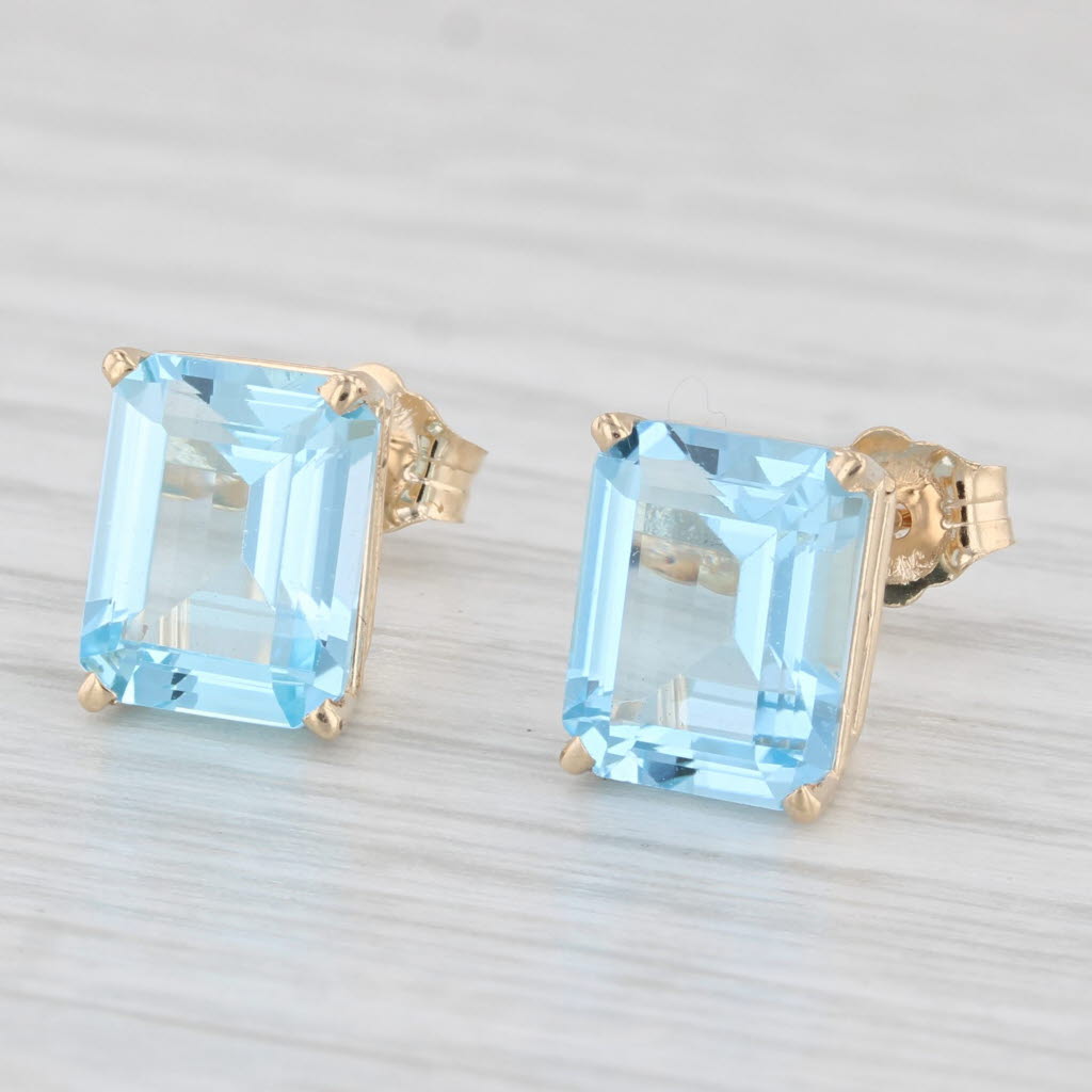 Light Gray 6ctw Blue Topaz Stud Earrings 14k Yellow Gold Emerald Cut Solitaires