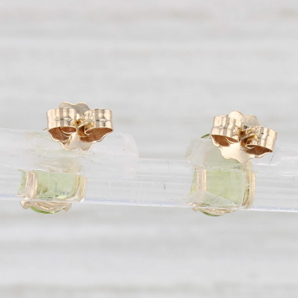 Light Gray 1.54ctw Oval Peridot Solitaire Stud Earrings 14k Yellow Gold