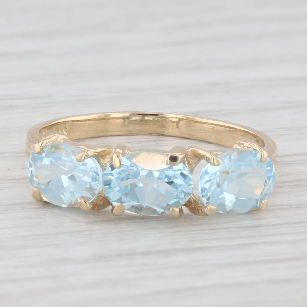 Light Gray 3ctw 3-Stone Oval Blue Topaz Ring 14k Yellow Gold Size 8