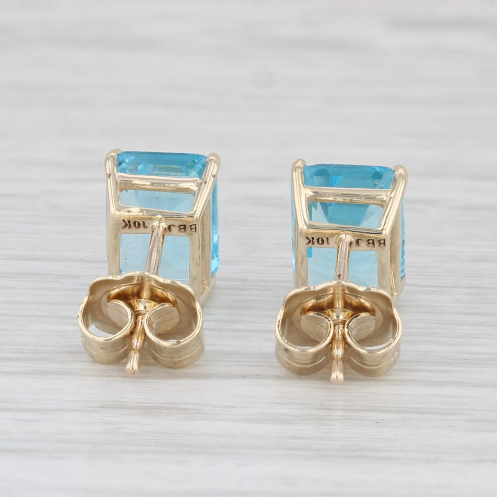 Light Gray 4ctw Blue Topaz Stud Earrings 10k Yellow Gold Emerald Cut Solitaires