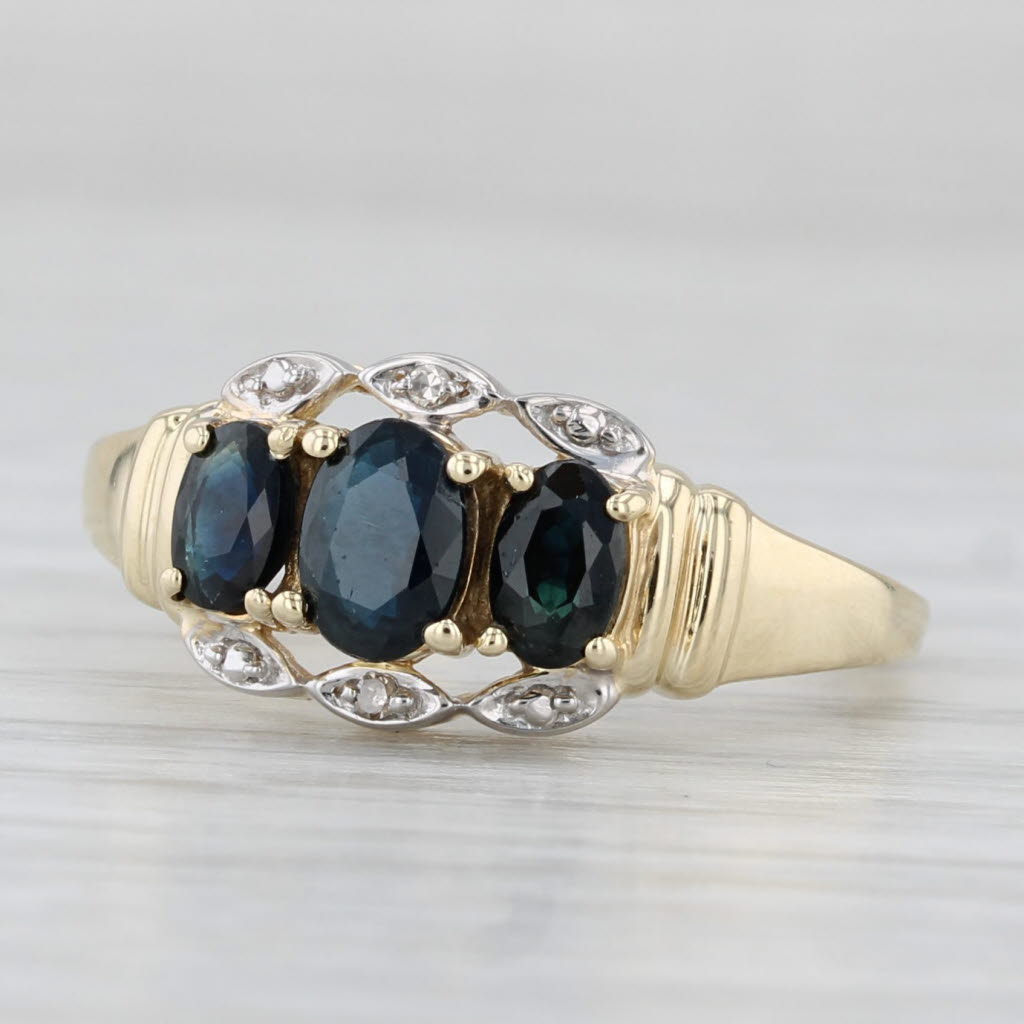 Light Gray 1.10ctw Blue Sapphire Oval 3-Stone Ring 10k Yellow Gold Diamond Accents Size 7.5