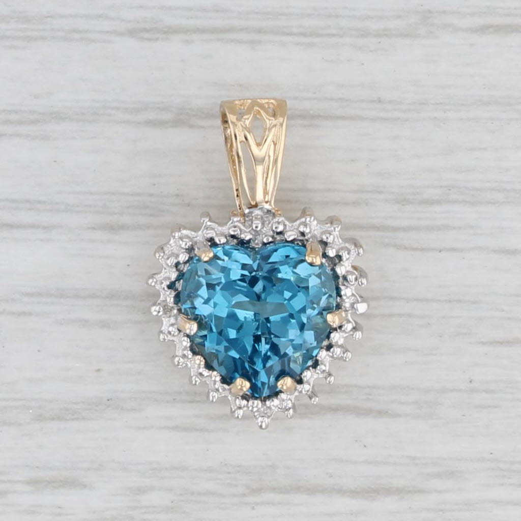 Light Gray 0.490ctw London Blue Topaz Heart Diamond Halo Pendant 10k Yellow Gold