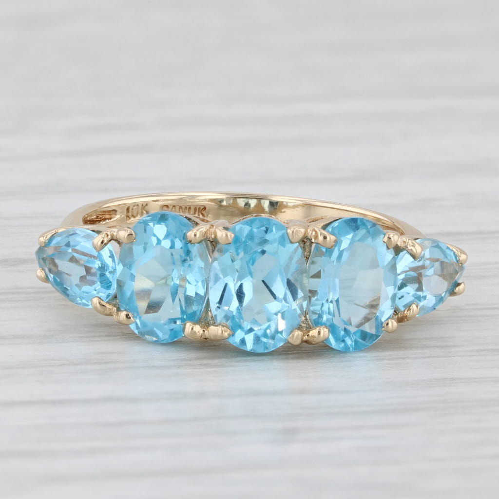 Light Gray Oval 3-Stone 4ctw Blue Topaz Ring 10k Yellow Gold Size 7