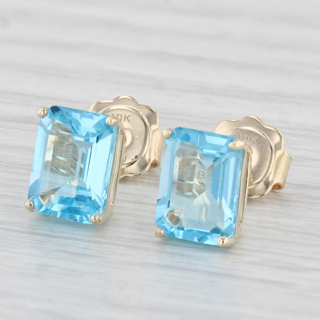 Light Gray 4ctw Blue Topaz Stud Earrings 10k Yellow Gold Emerald Cut Solitaires