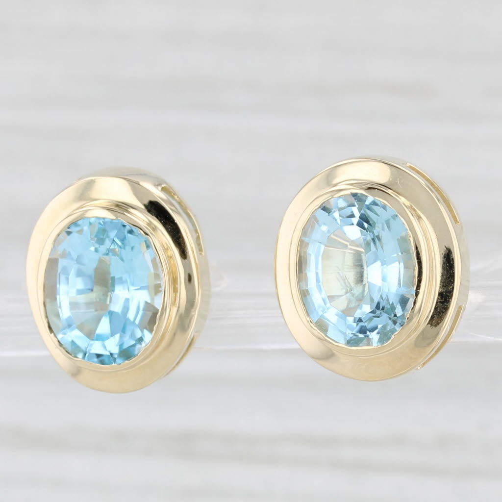 Light Gray 7.30ctw Oval Blue Topaz Stud Earrings 14k Yellow Gold