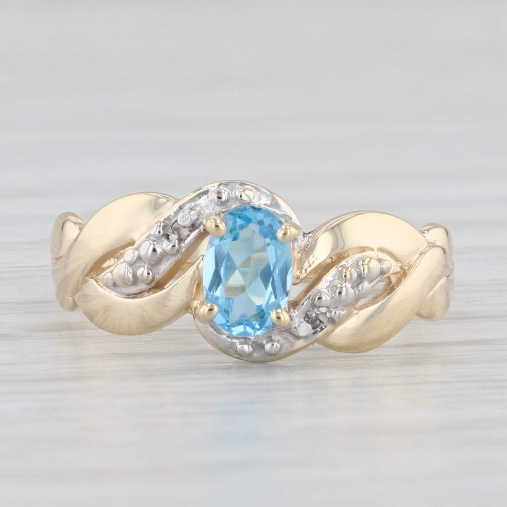 Light Gray 0.40ct Oval Blue Topaz Ring 10k Yellow Gold Diamond Accents Size 6.5