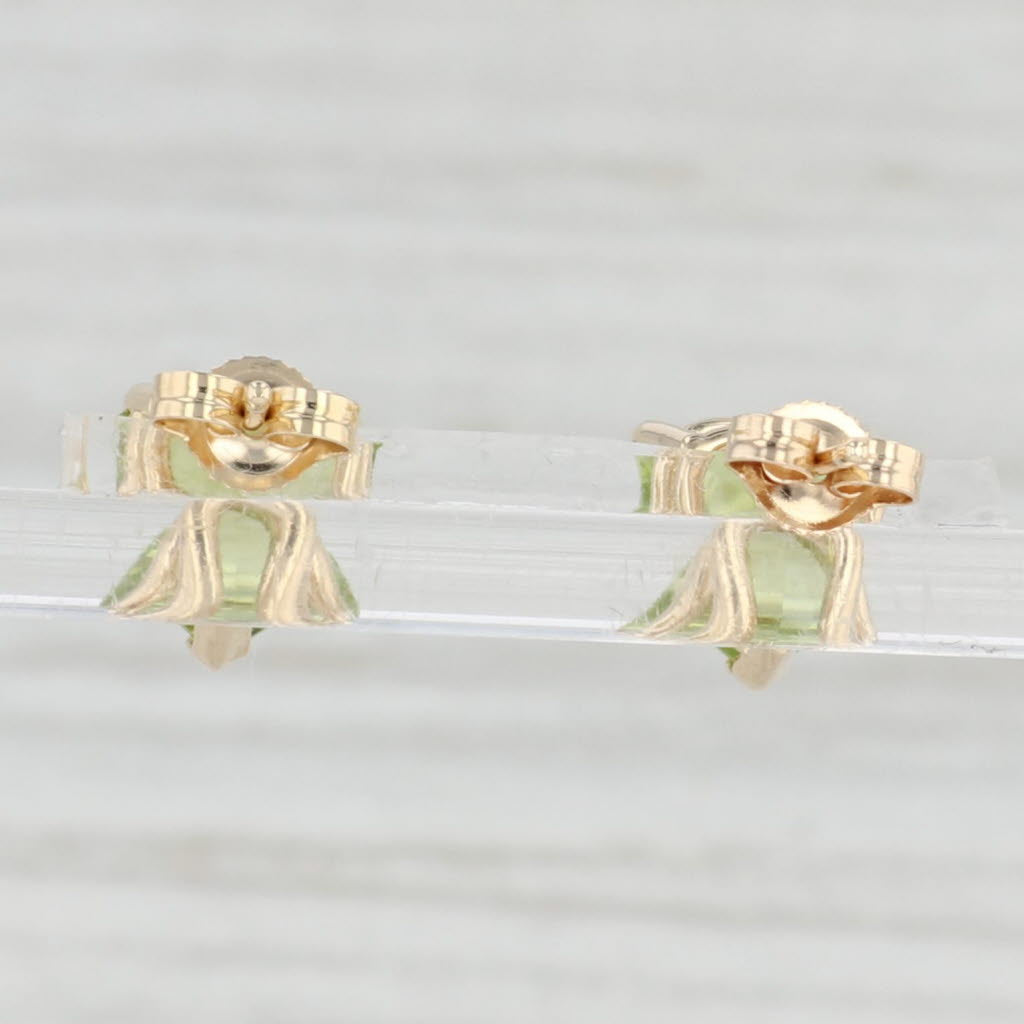 Light Gray 3.20ctw Green Peridot Stud Earrings 14k Yellow Gold Trillion Cut Studs