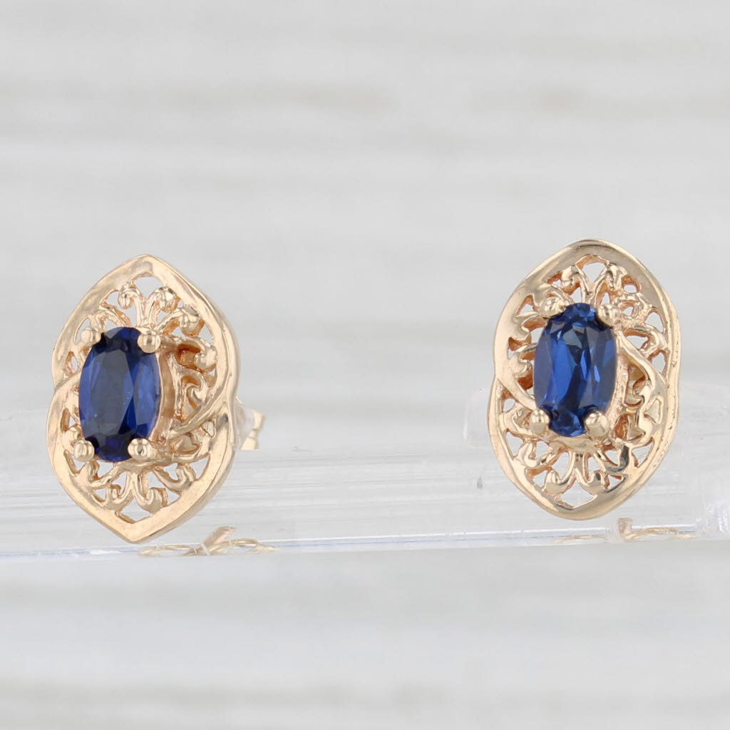 Light Gray 0.60ctw Lab Created Blue Sapphire Stud Earrings 10k Yellow Gold Oval Solitaires