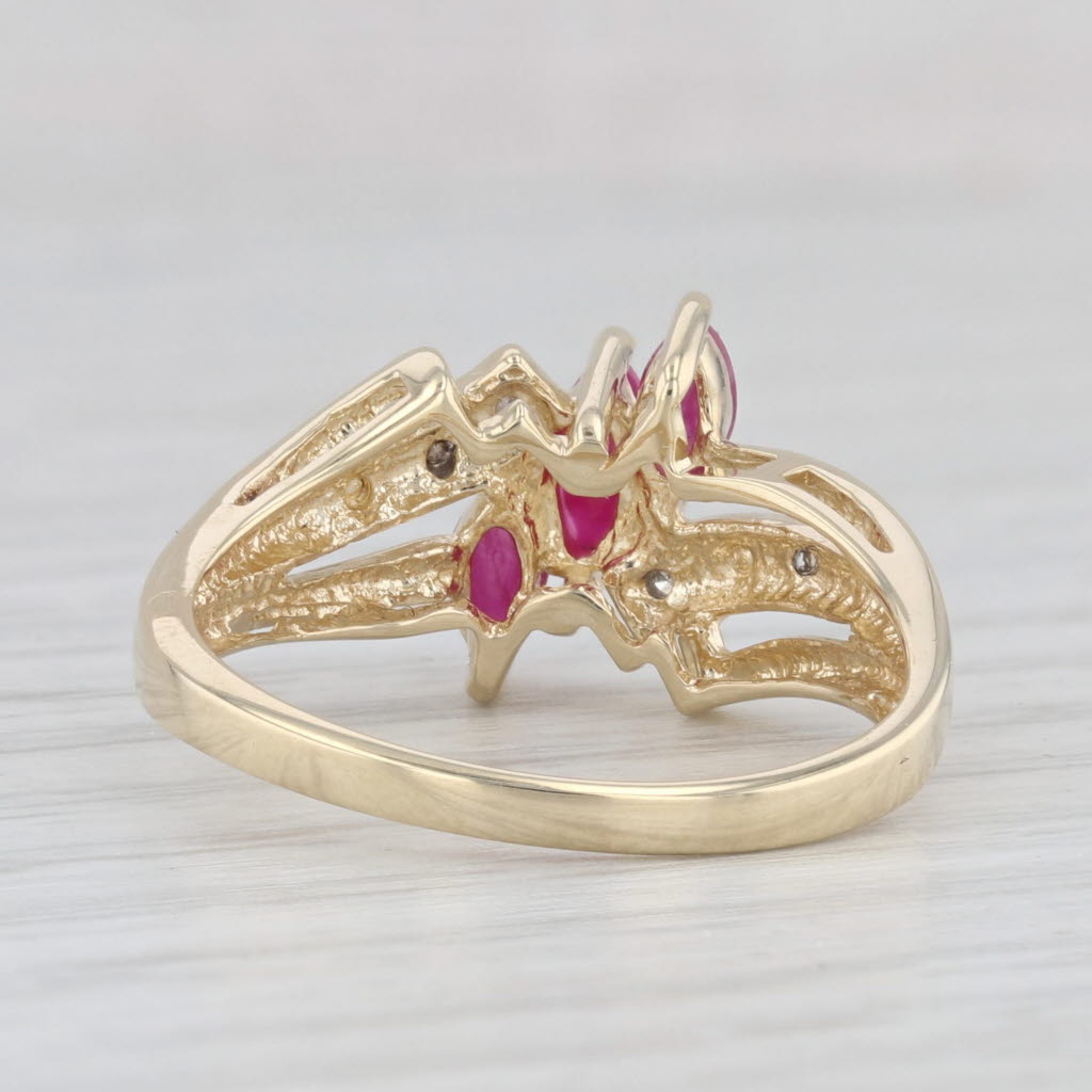 Light Gray 0.70ctw Lab Created Ruby 3-Stone Bypass Ring 10k Gold Size 7.25 Diamond Accents