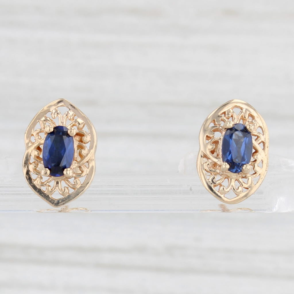 Light Gray 0.60ctw Lab Created Blue Sapphire Stud Earrings 10k Yellow Gold Oval Solitaires