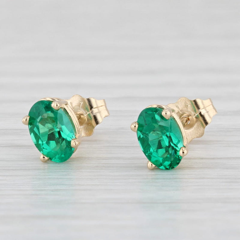 0.94ctw Lab Created Emerald Stud Earrings 14k Yellow Gold Oval Solitaires