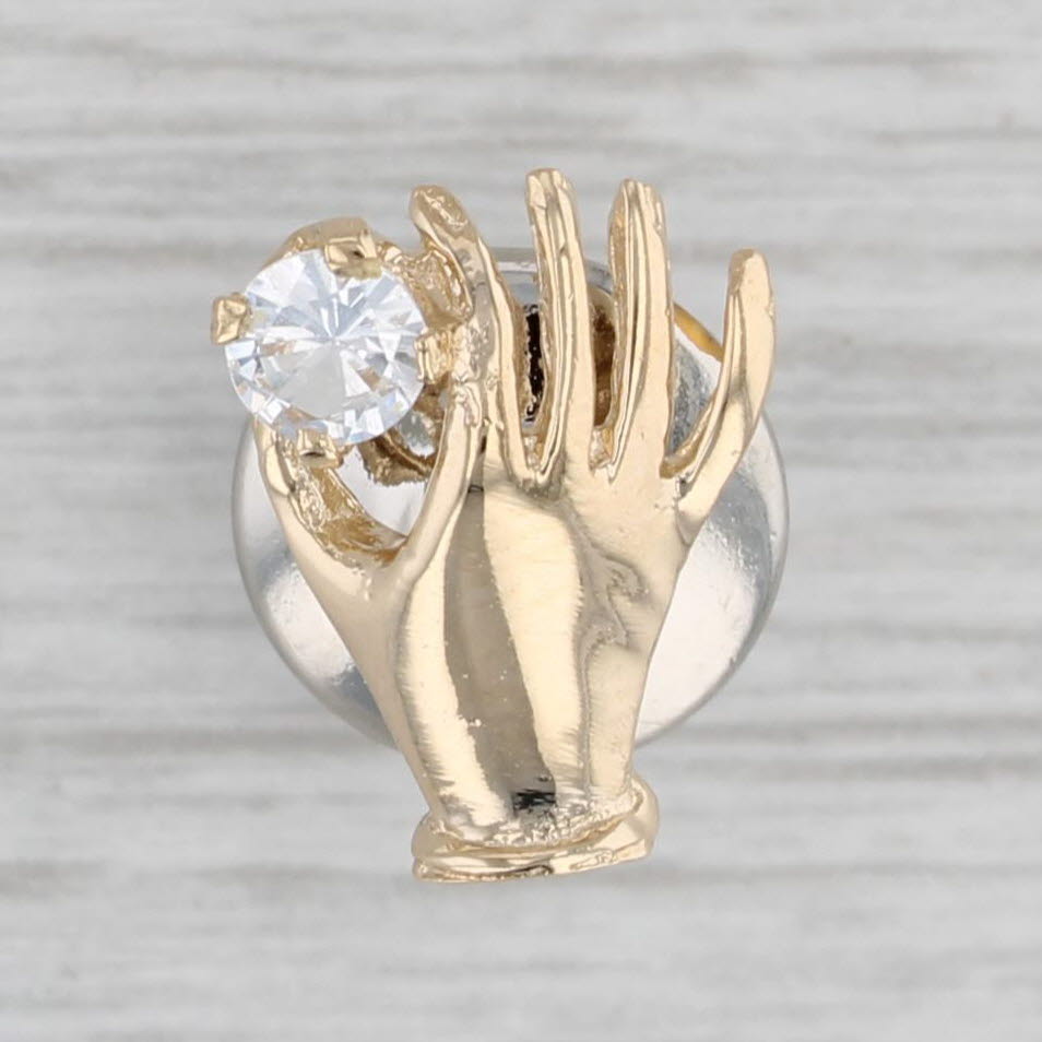 Gray Hand Holding 0.20ct Cubic Zirconia Pin 14k Yellow Gold Lapel