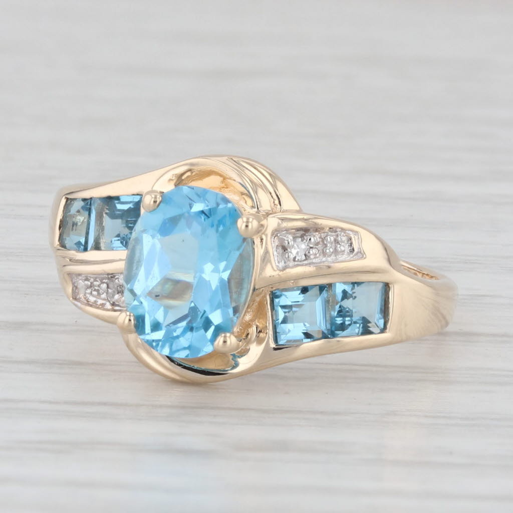 Light Gray 2.30ctw Oval Blue Topaz Bypass Ring 10k Yellow Gold Size 7.25 Diamond Accents