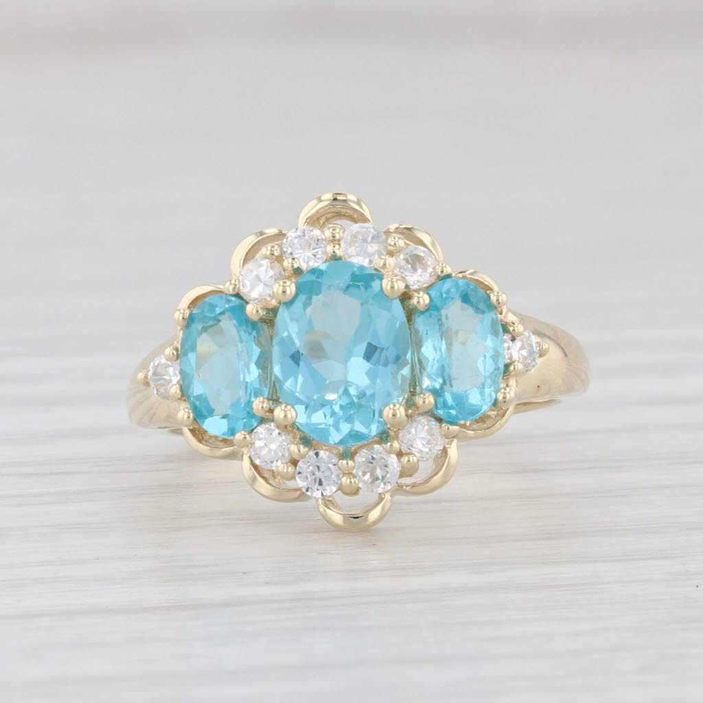 Light Gray 2.31ctw Blue Apatite 3-Stone Cubic Zirconia Ring 10k Yellow Gold Size 7