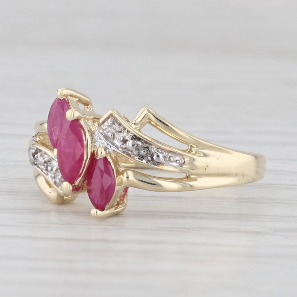 Light Gray 0.70ctw Lab Created Ruby 3-Stone Bypass Ring 10k Gold Size 7.25 Diamond Accents