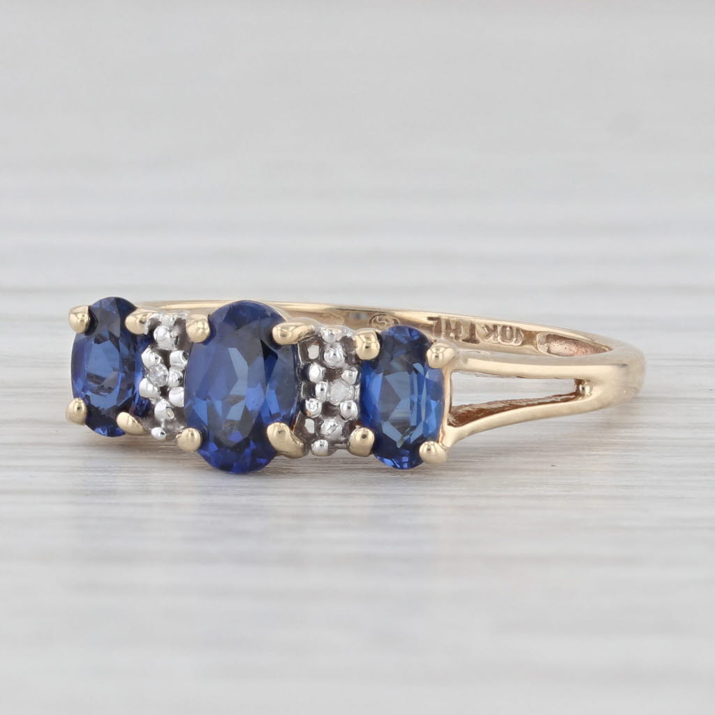 Light Gray 1.20ctw Lab Created Blue Sapphire 3-Stone Ring 10k Yellow Gold Size 7