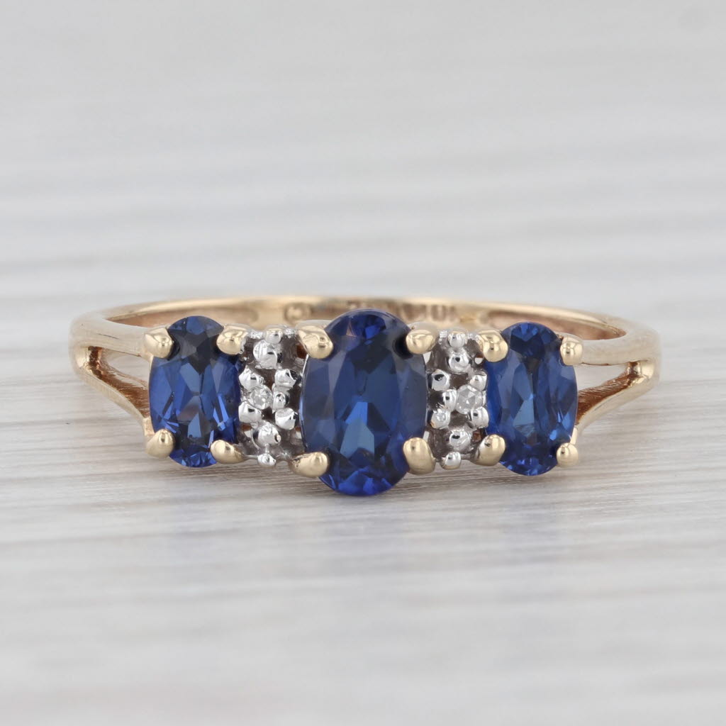 Light Gray 1.20ctw Lab Created Blue Sapphire 3-Stone Ring 10k Yellow Gold Size 7