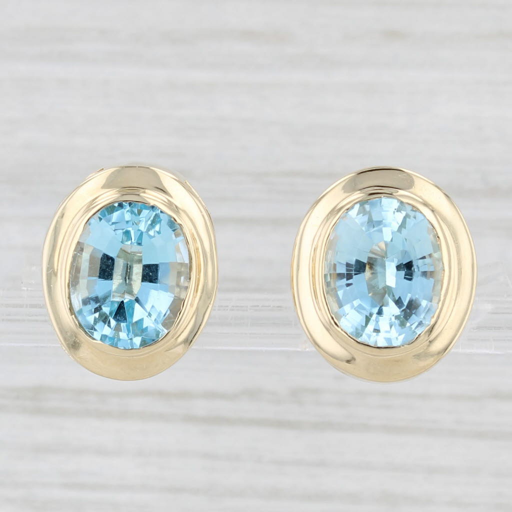 Light Gray 7.30ctw Oval Blue Topaz Stud Earrings 14k Yellow Gold