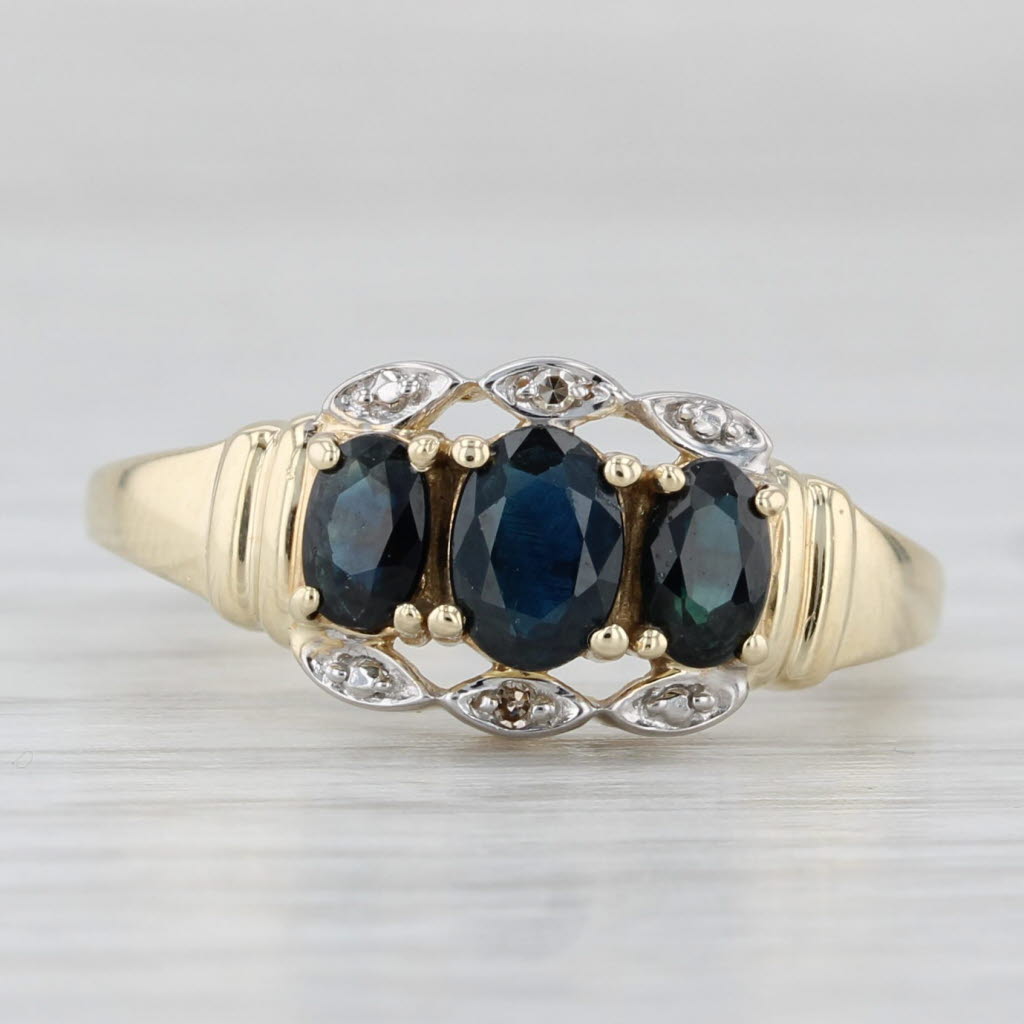 Light Gray 1.10ctw Blue Sapphire Oval 3-Stone Ring 10k Yellow Gold Diamond Accents Size 7.5